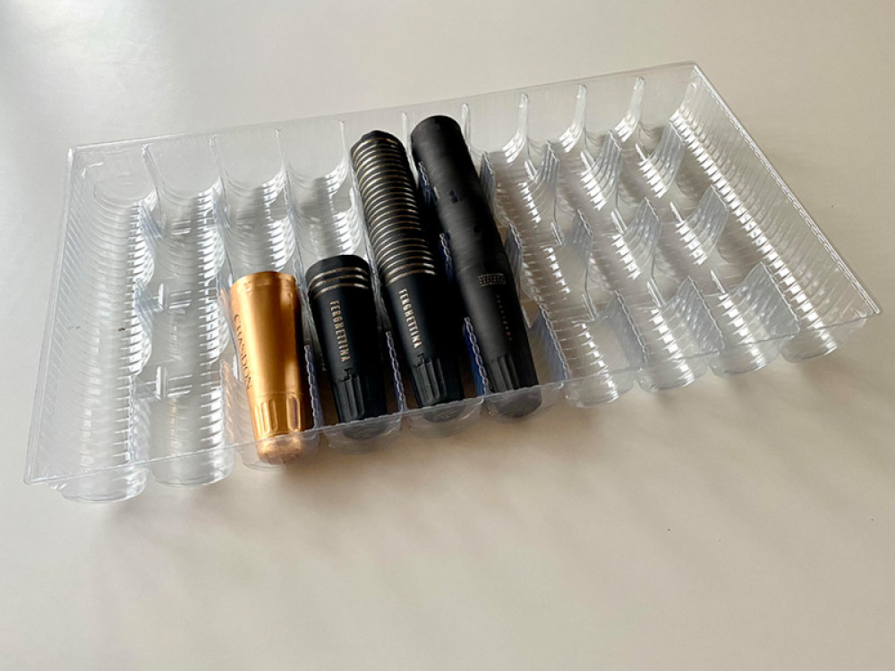 Thermoformed trays for sparkling wine capsules